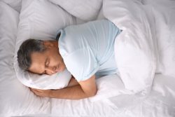 Man sleeping well after taking steps to mange sleep apnea