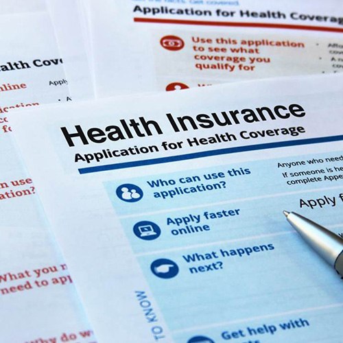 Health insurance documents and pen