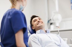 Happy patient speaking with dental team member