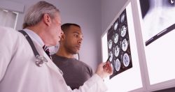 Doctor and patient reviewing brain scans