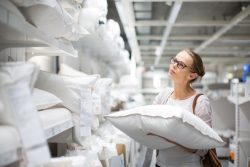 Woman in store, shopping for pillows