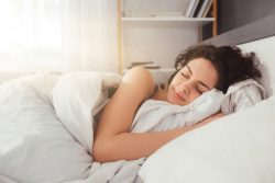 Woman sleeping peacefully in comfortable bed