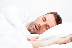 Man sleeping in bed, snoring