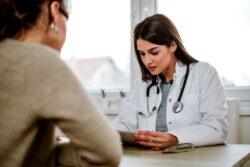 Concerned doctor looking at patient’s file