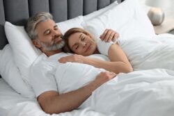 Mature couple sleeping in bed