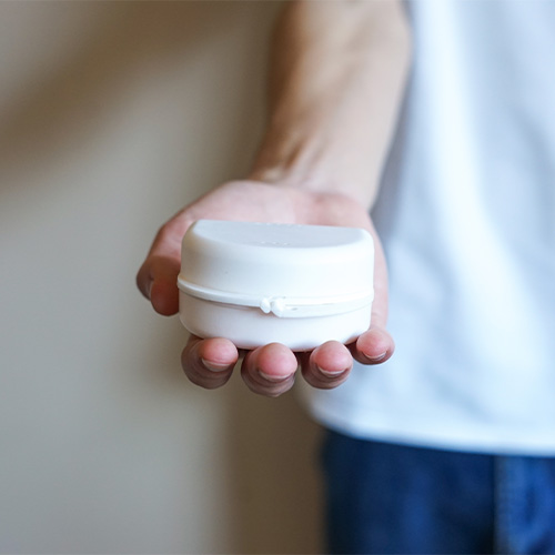 Person holding storage case for oral appliance